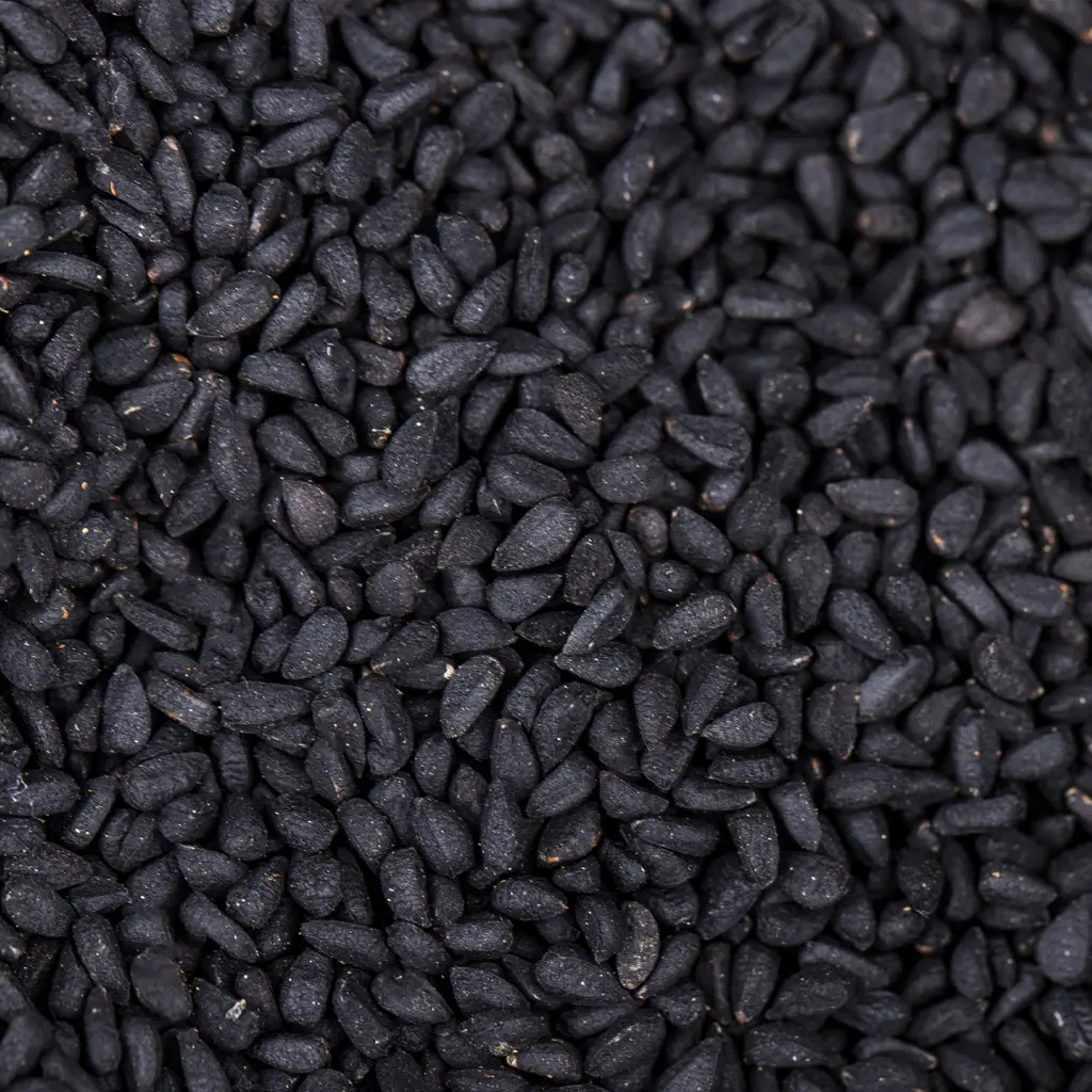 Dark amber to black essential oil derived from steam-distilled black cumin seeds showcasing natural aroma and purity.